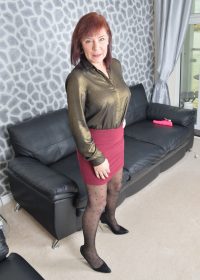 Naughty redhead plays with her tits and snatch in the living room