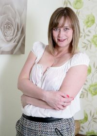 Naughty, mature housewife teases herself while waiting for her man to return