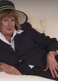 Slutty British lady strips naked and plays with her assets